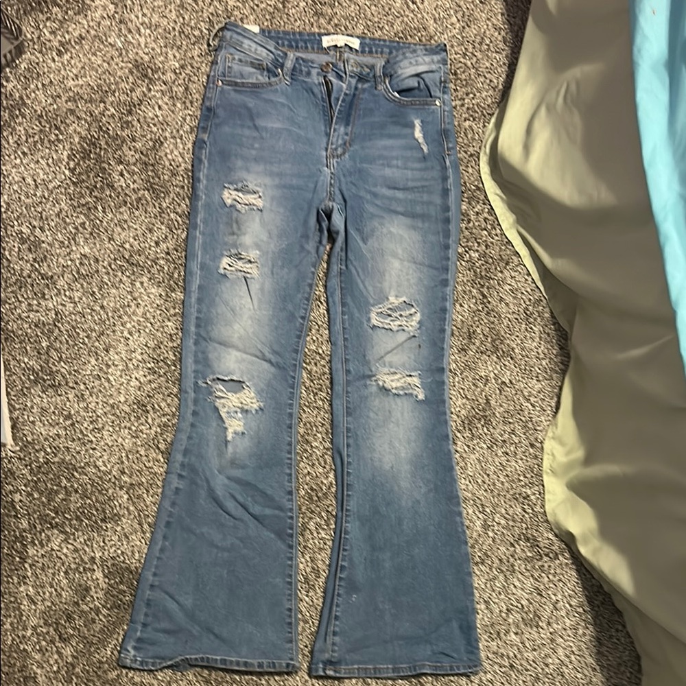 light blue ripped flared jeans
